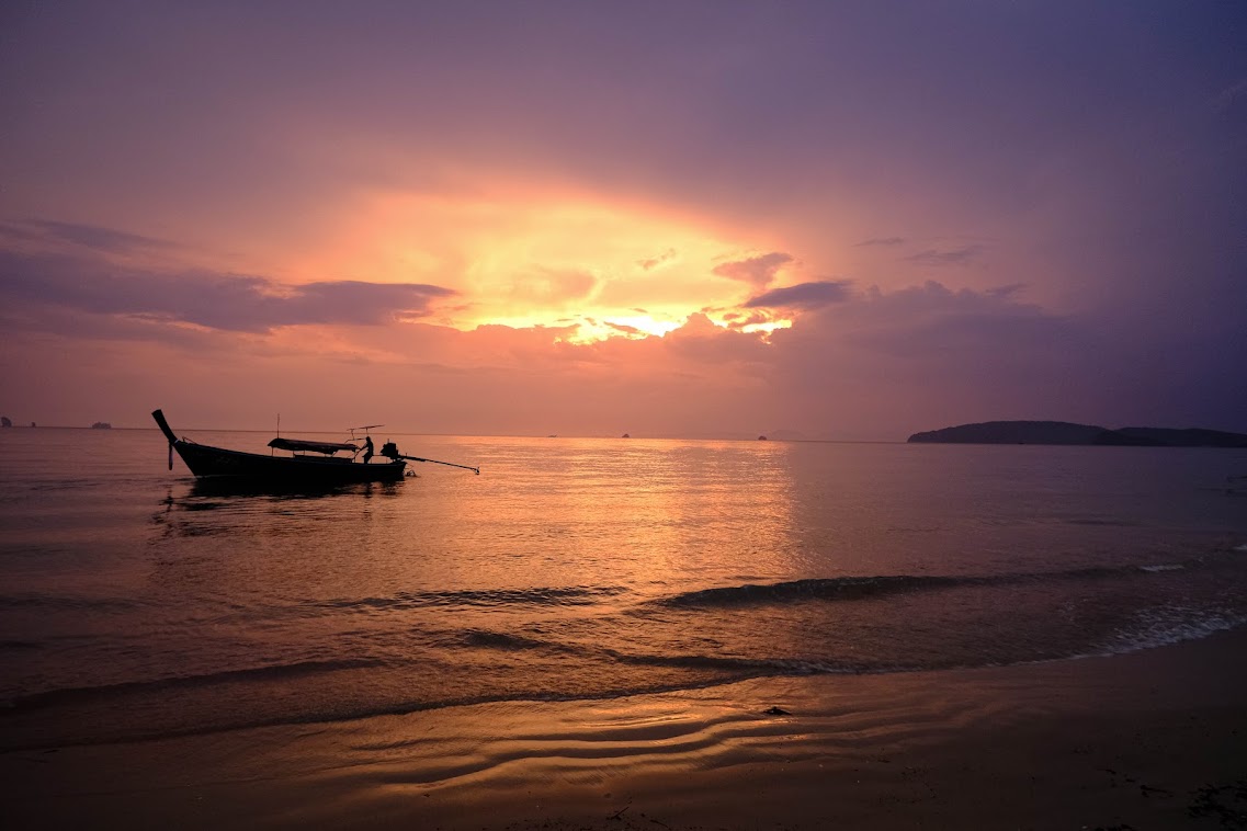 long tail boat during sunset in ao nang beach krabi